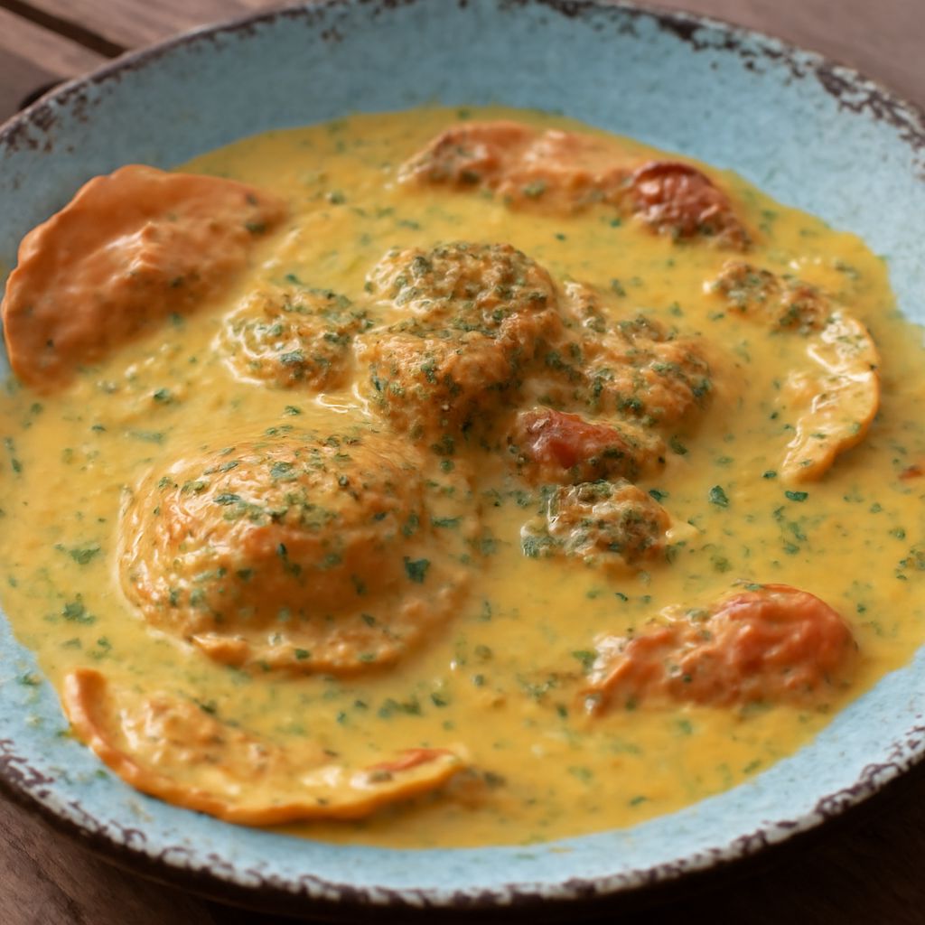 Butternut squash ravioli with creamy sauce and vegetable soup