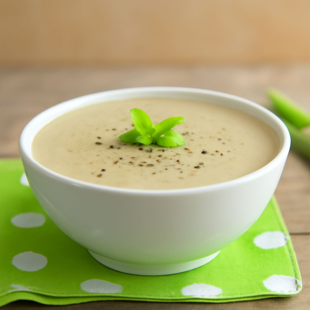 A bowl of homemade cream of celery soup with potato celery soup and vegan cream of celery soup varieties.